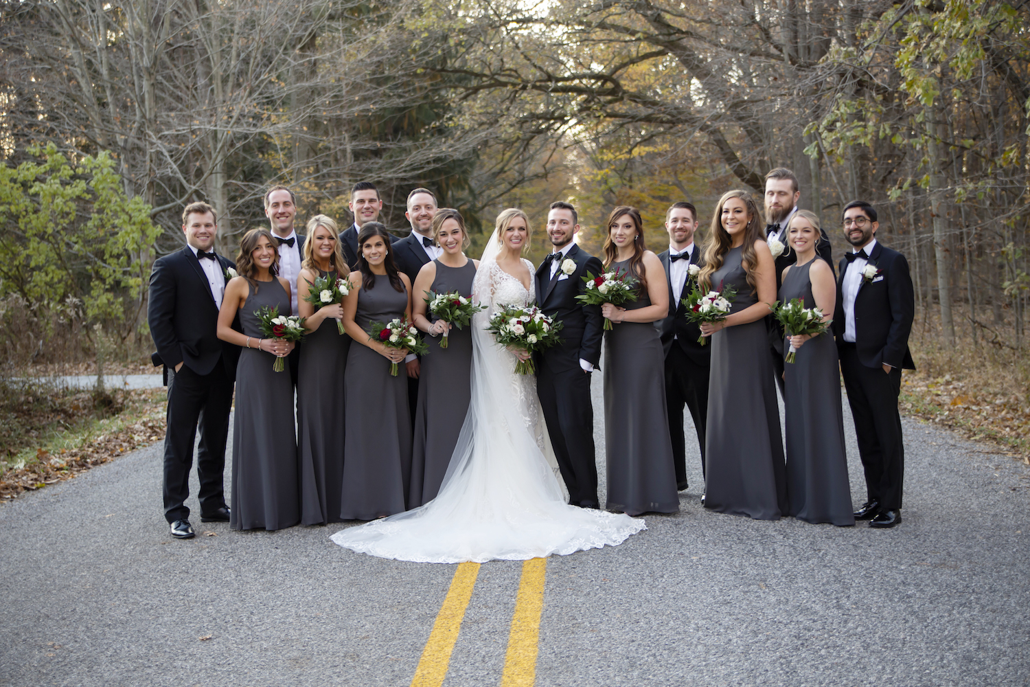 Bridal party standing on road for rustic Michigan wedding