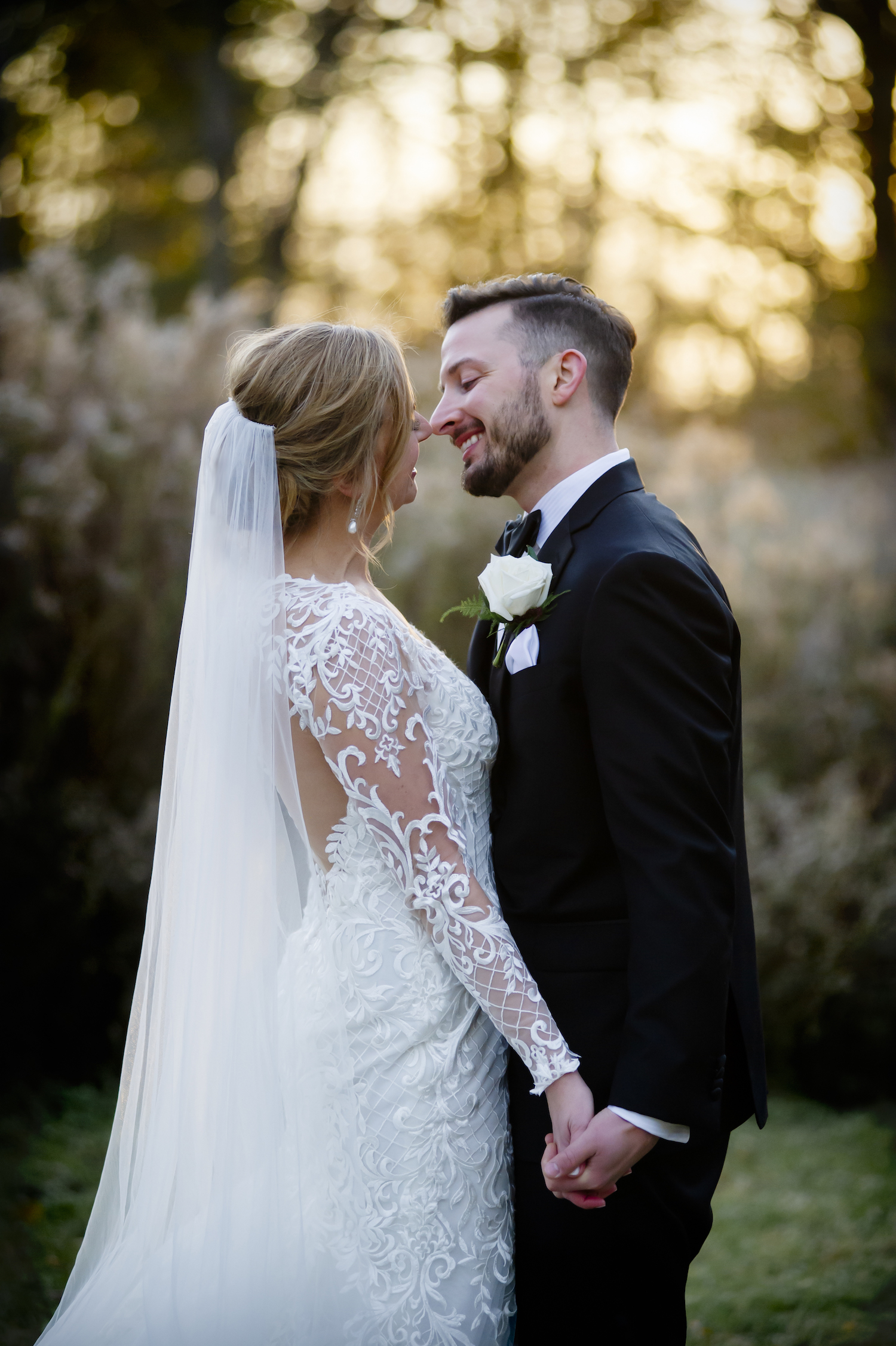 Bride and groom kissing during rustic Michigan wedding