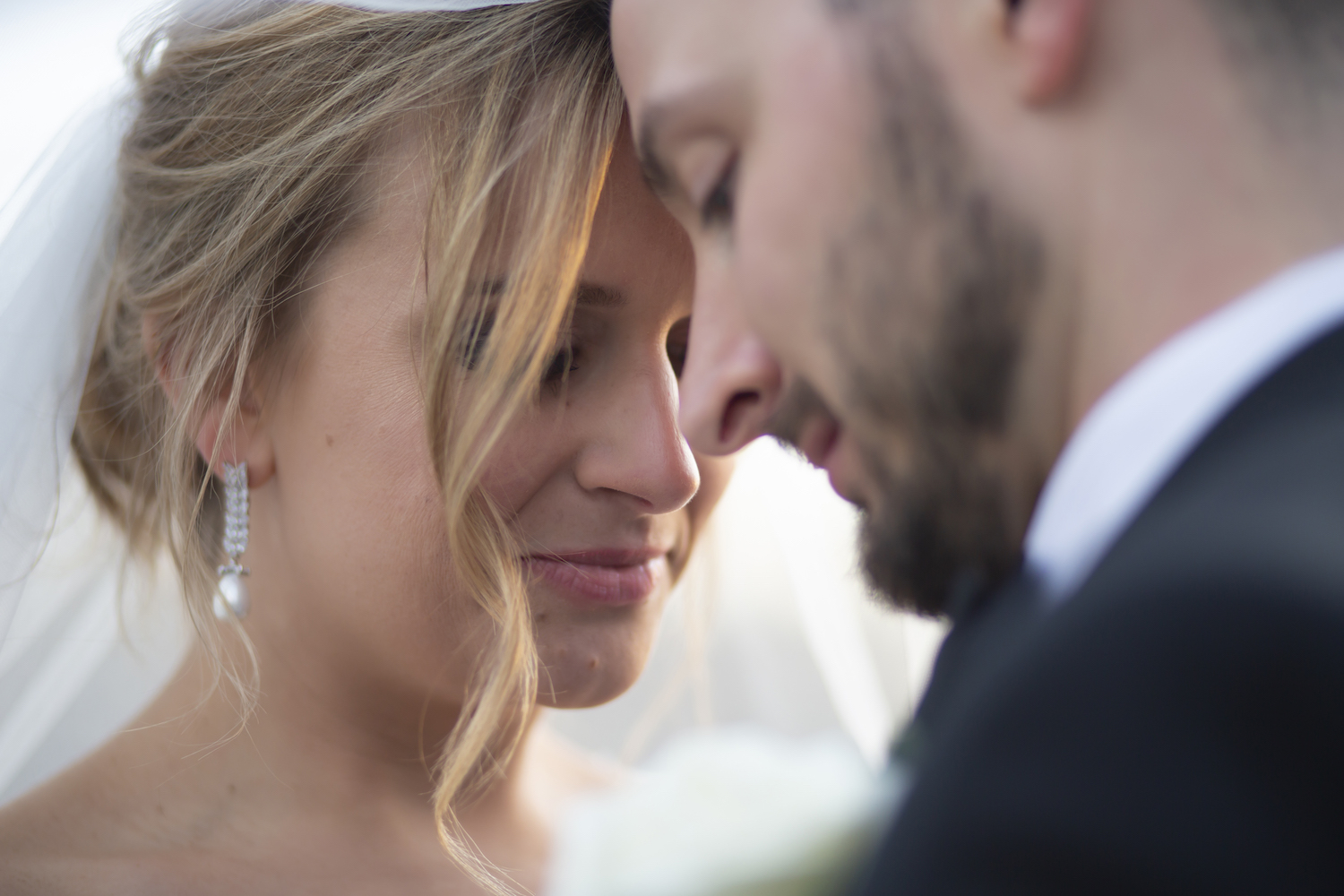 Bride and groom touching foreheads