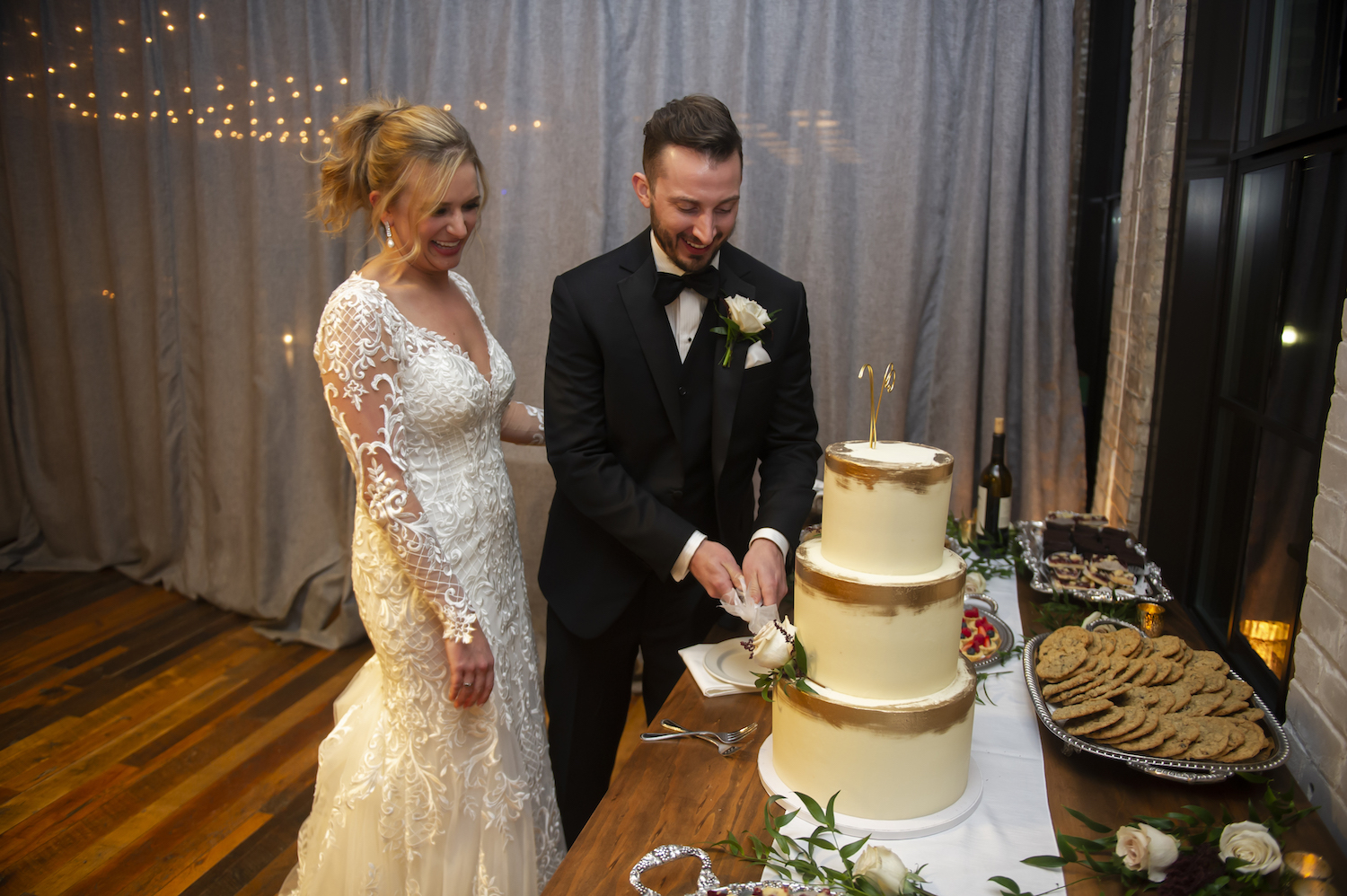 Bride and groom cutting cake smiling