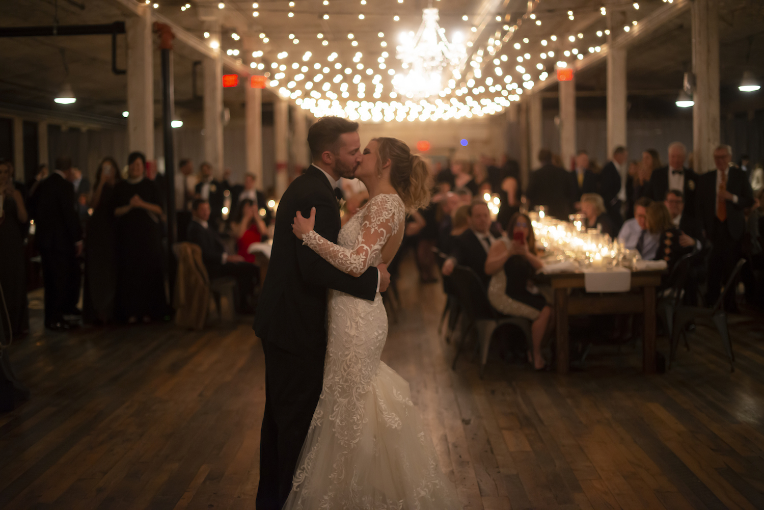 Bride and groom kissing during first dance at rustic Michigan wedding