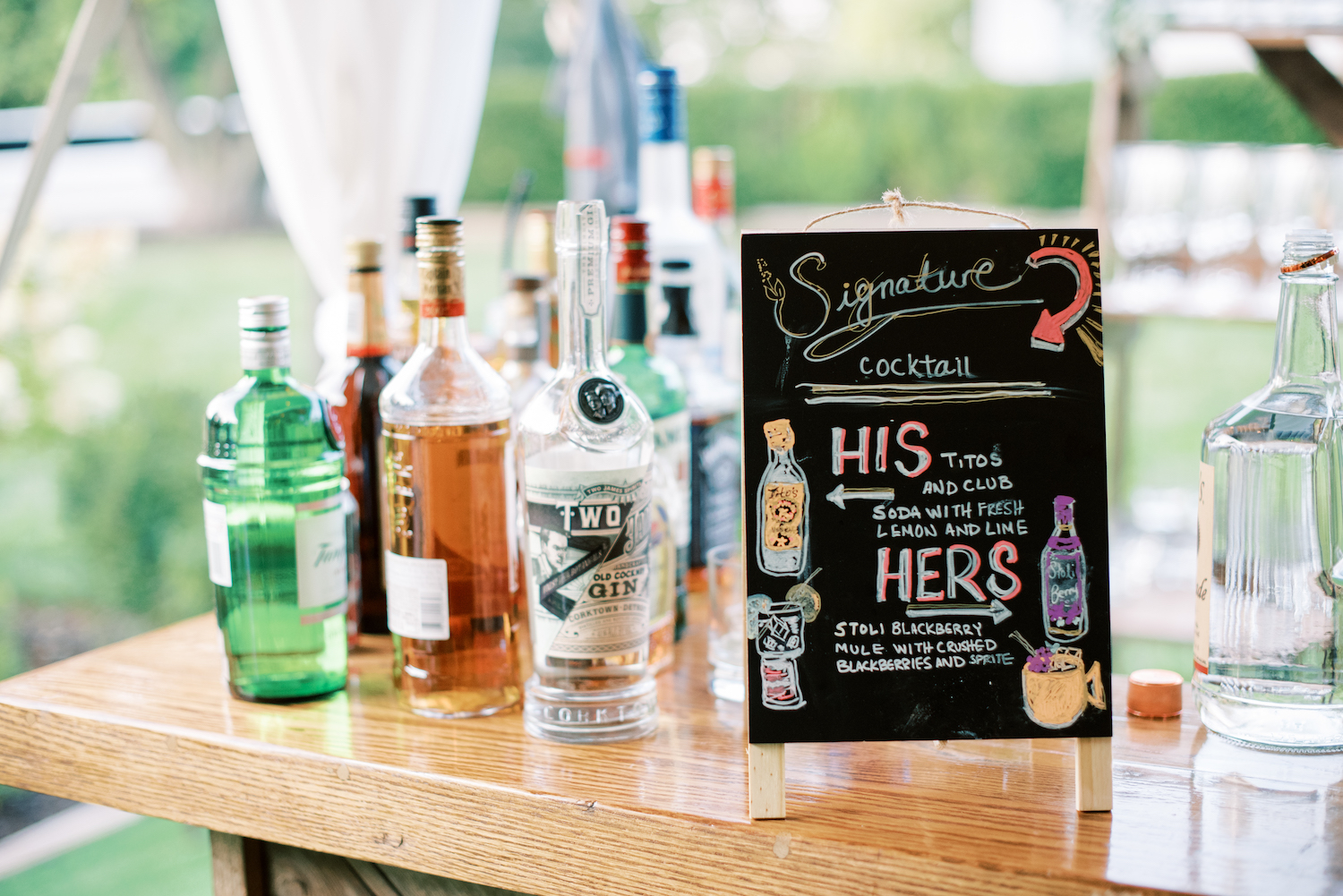 Signature drinks sign with alcohol bottles at apple blossom resort wedding