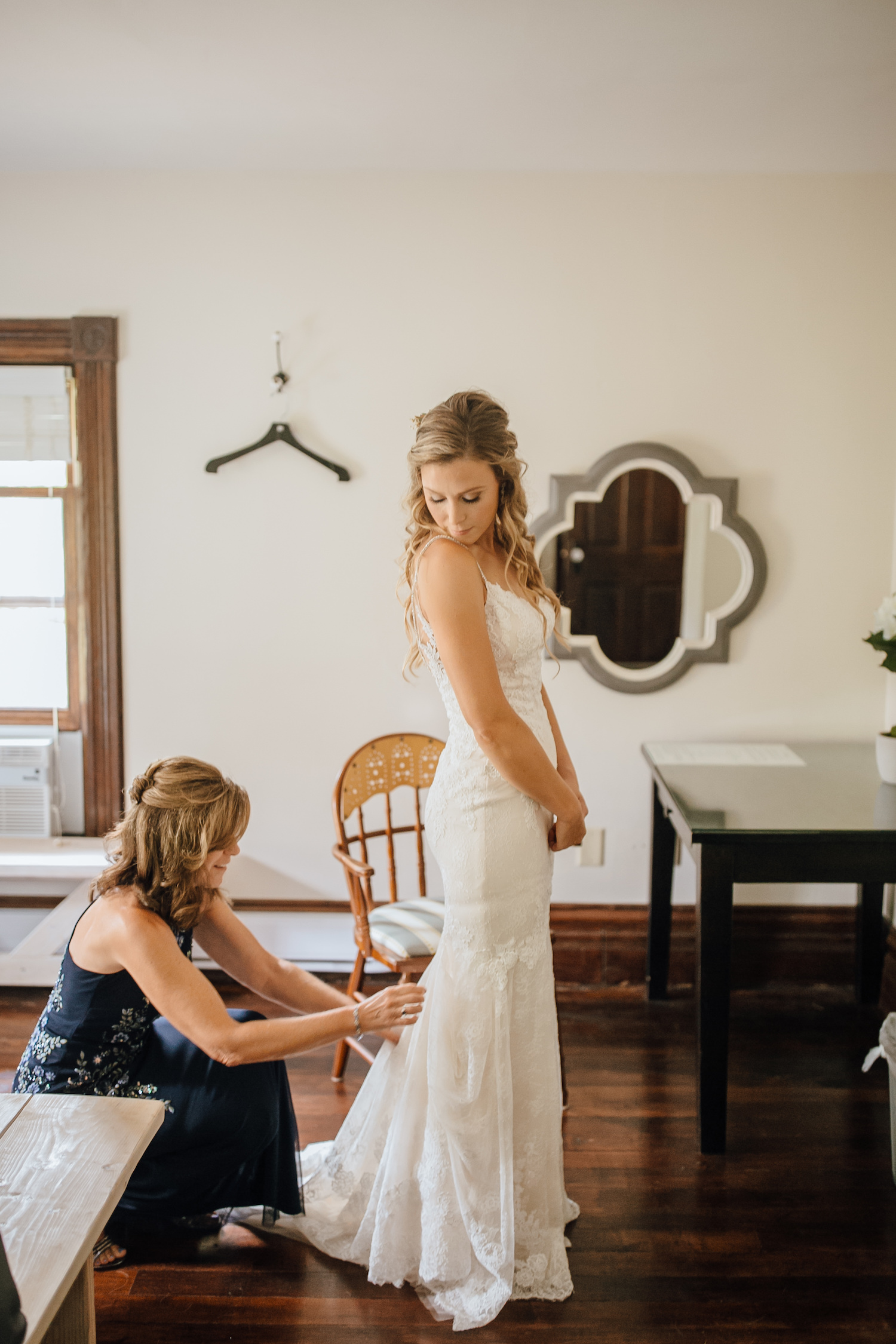 Mother of the bride bustling bride's dress