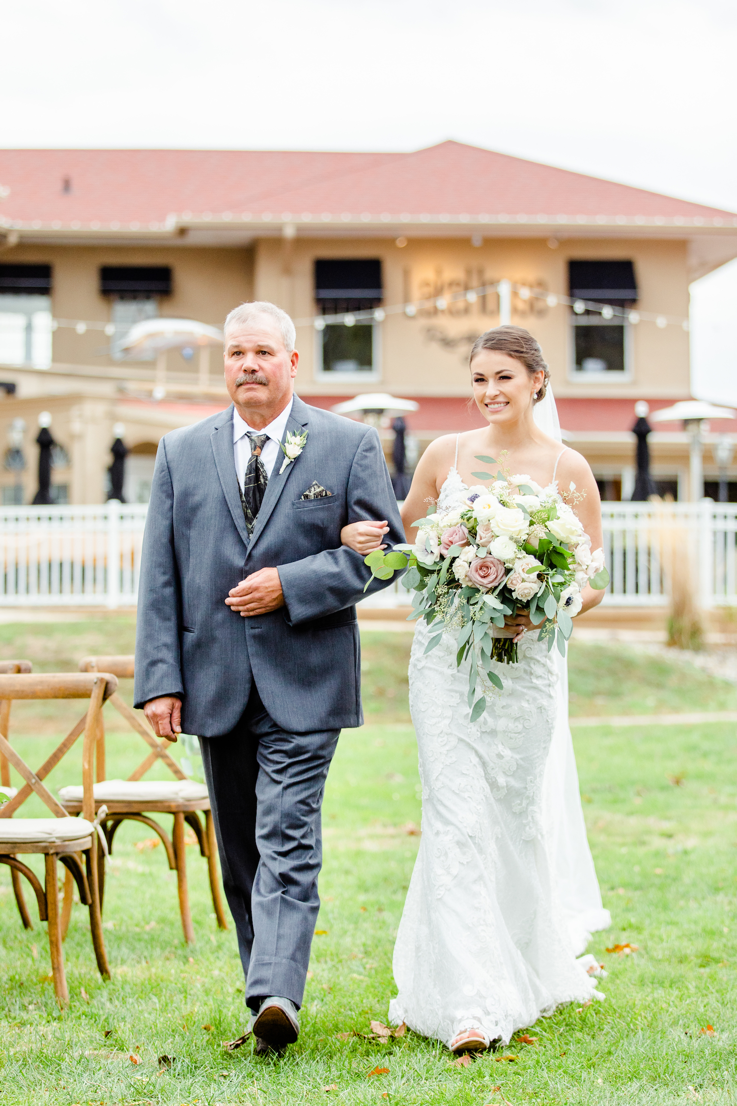 Bride and father walking down aisle for the lakehouse wedding