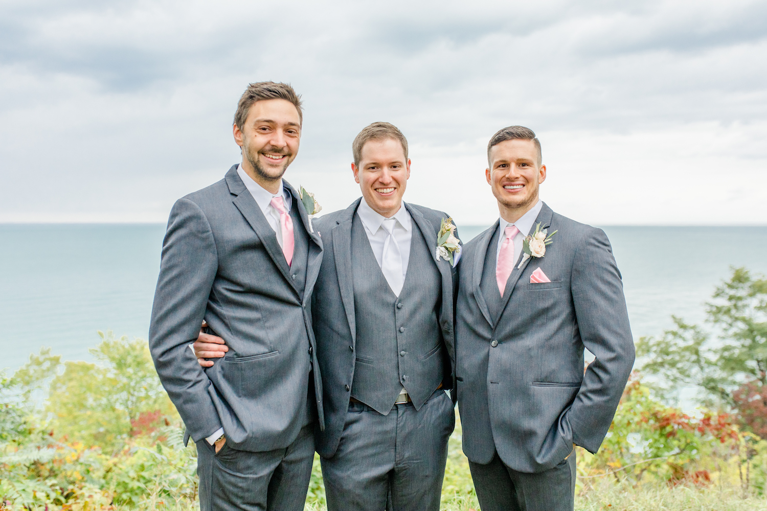 Groomsmen smiling at the lakehouse wedding