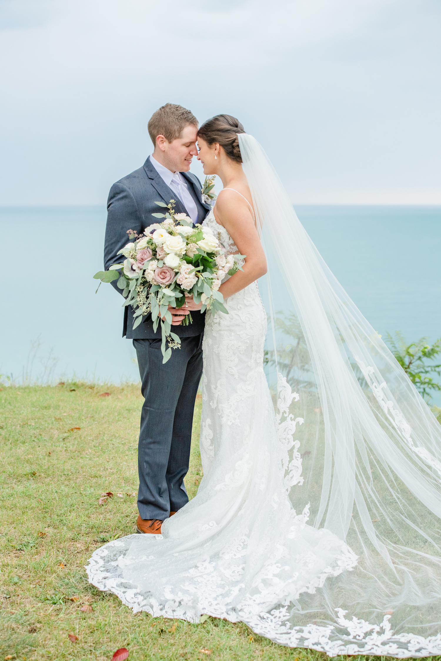 Bride and groom touching foreheads at the lakehouse wedding