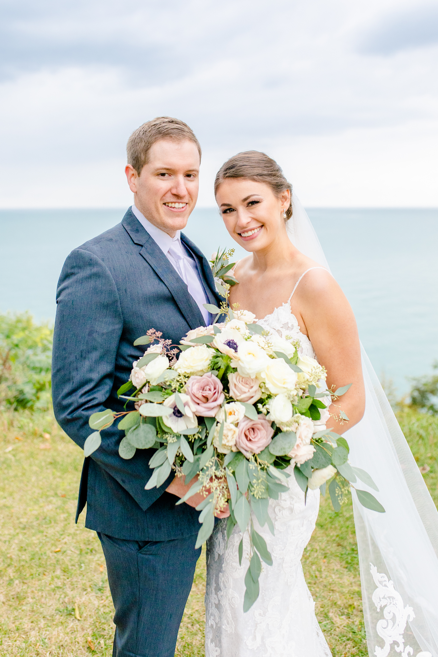 Bride and groom smiling at lakehouse wedding