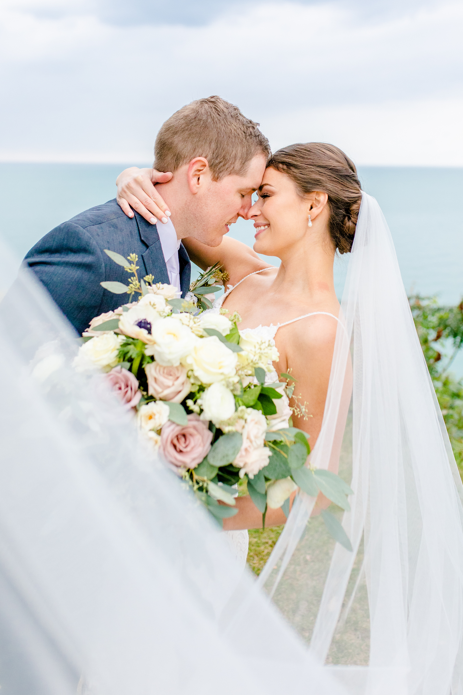 Bride and groom gazing at each other at lakehouse wedding