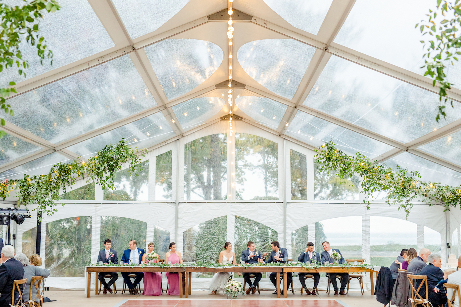 Bridal party table under tent of the lakehouse wedding