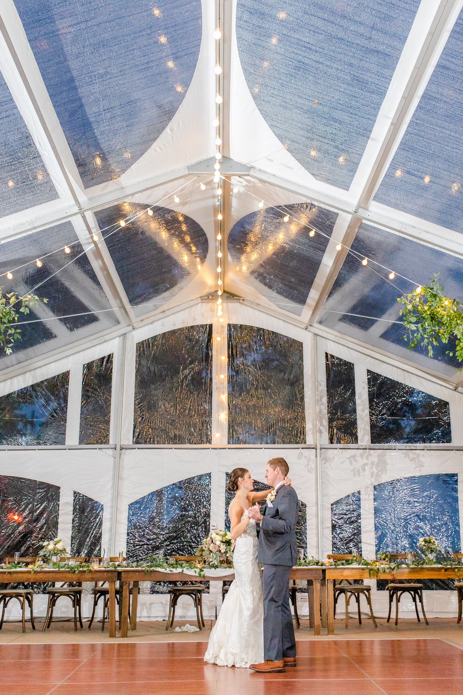 Bride and groom dancing under tent at the lakehouse wedding