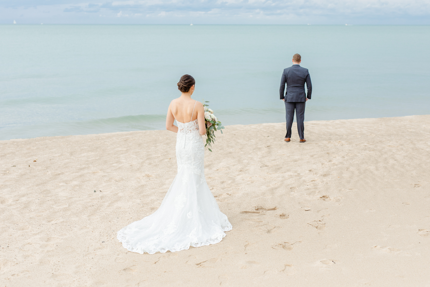 Bride and groom on beach of the lakehouse wedding