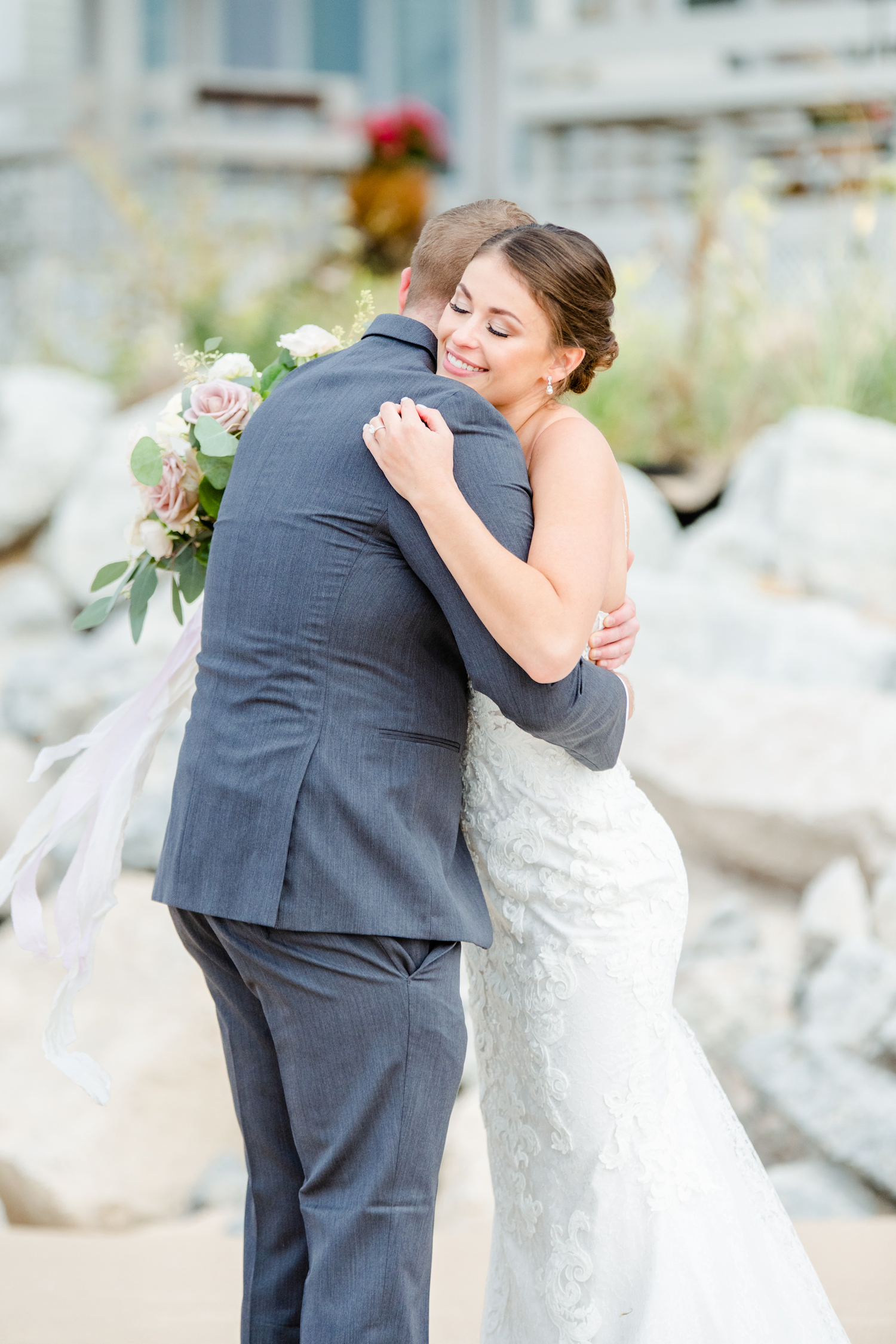 Bride and Groom hugging at their lakehouse wedding