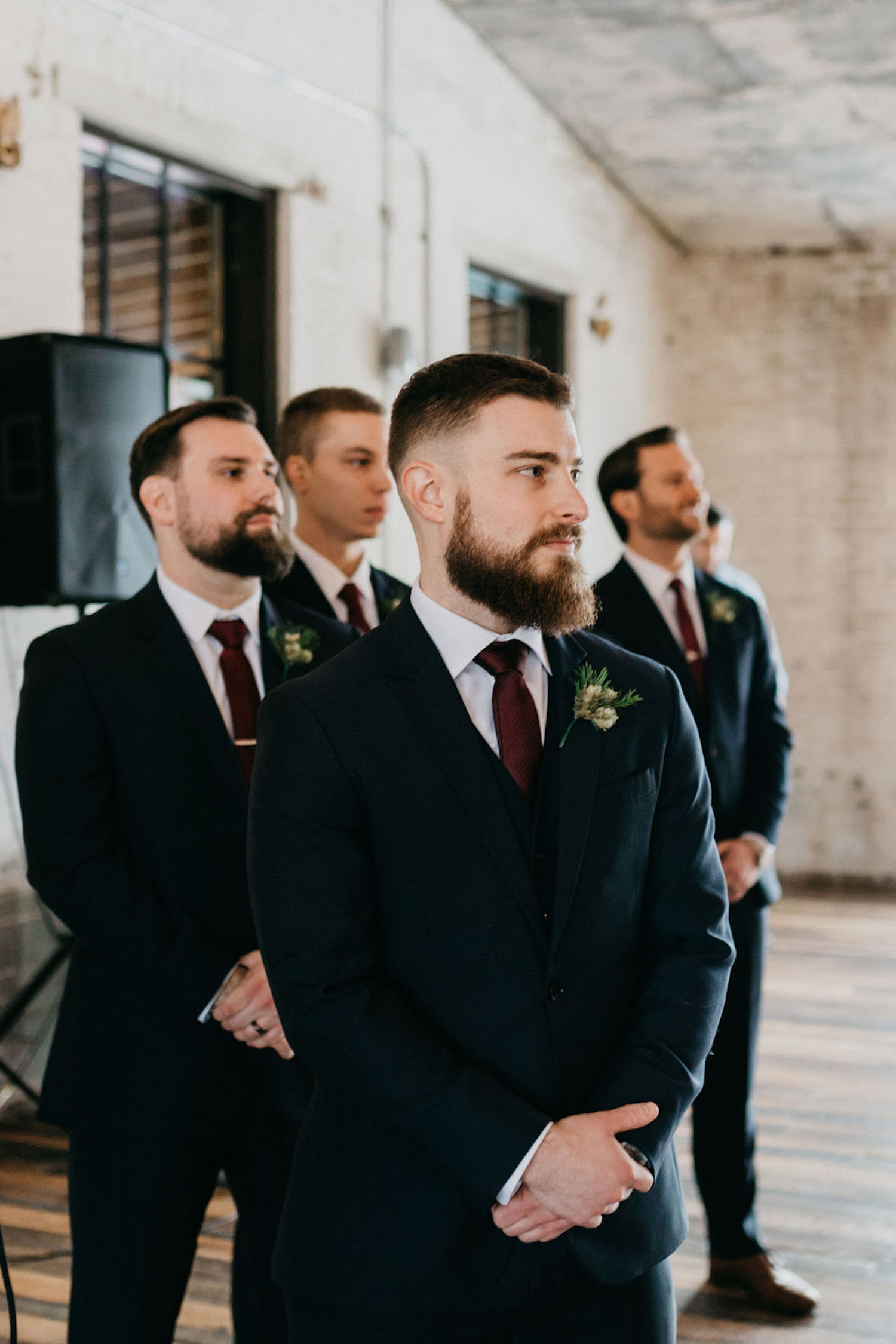 Groom standing with groomsman at Journeyman Distillery wedding