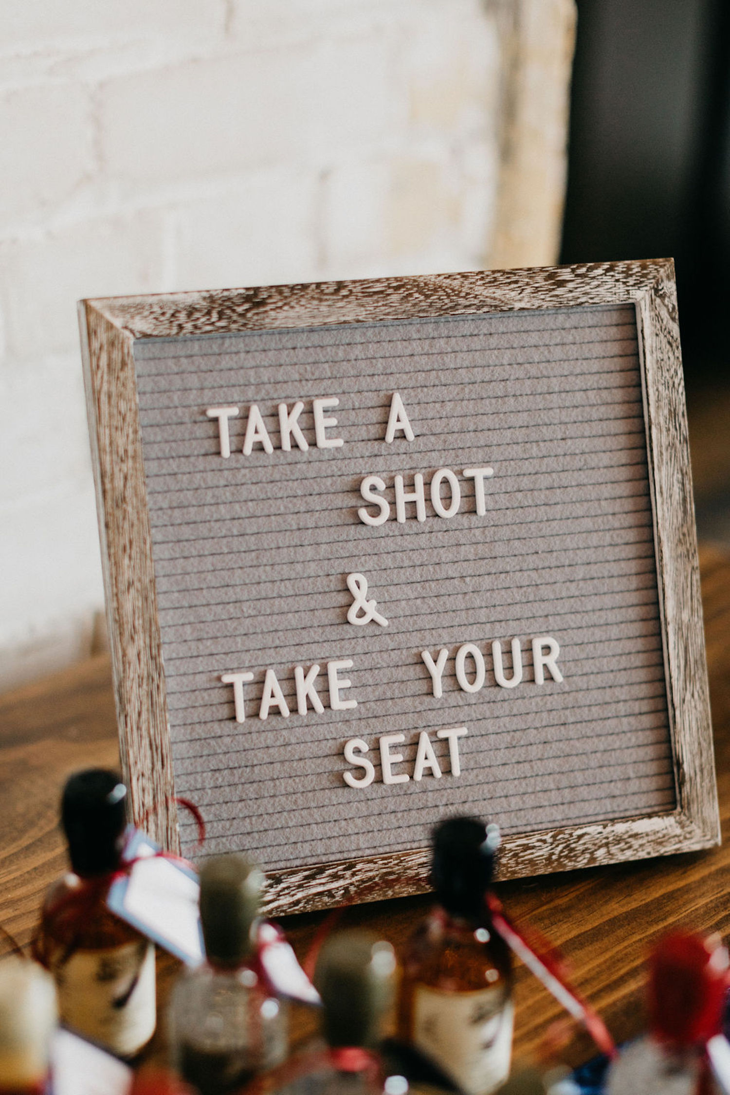 Take your seat sign for Journeyman Distillery wedding