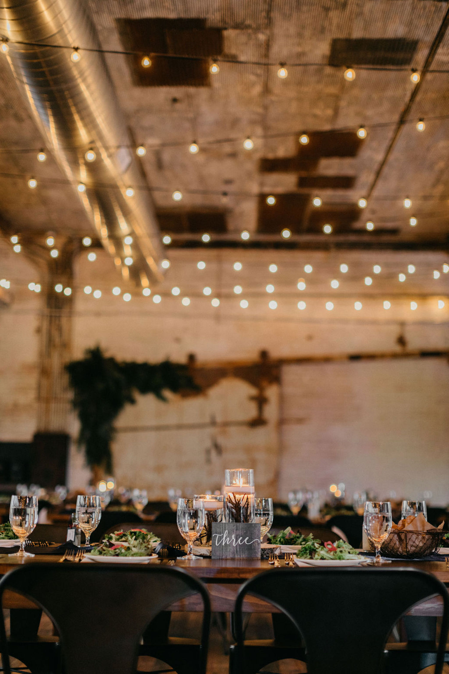 Lights over table of Journeyman Distillery wedding