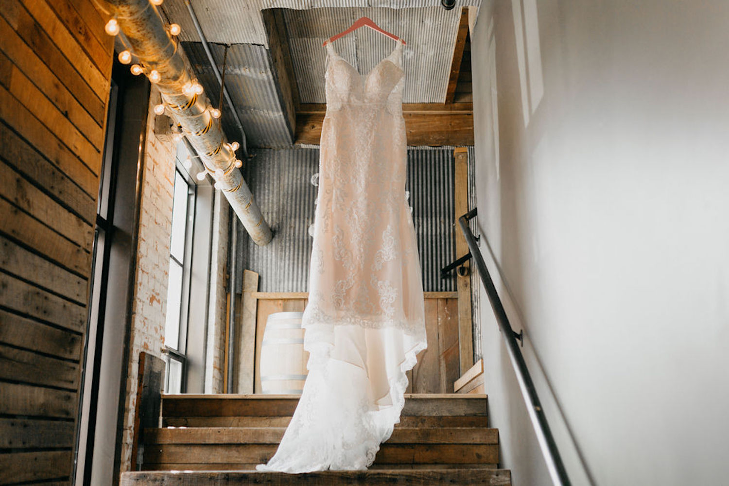 Journeyman Distillery Wedding gown hanging in stairway