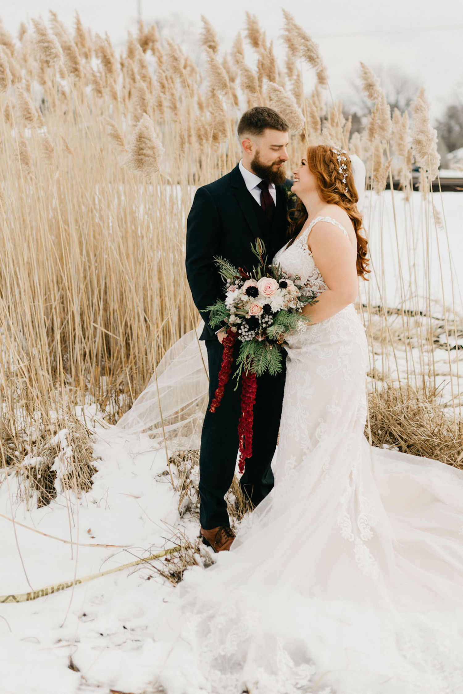 Bride and groom smiling in the snow