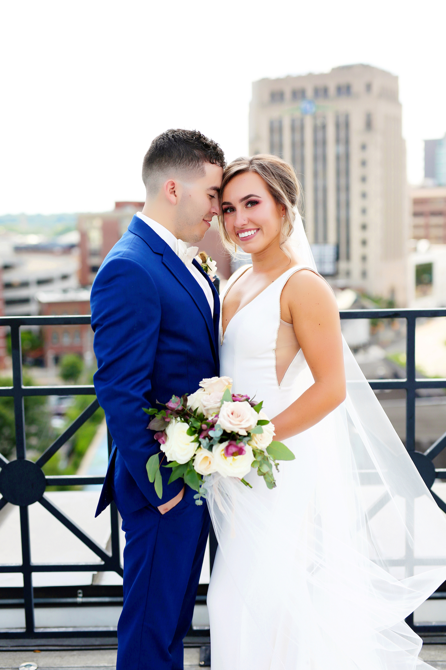 Bride and groom smiling downtown for Kalamazoo Michigan wedding