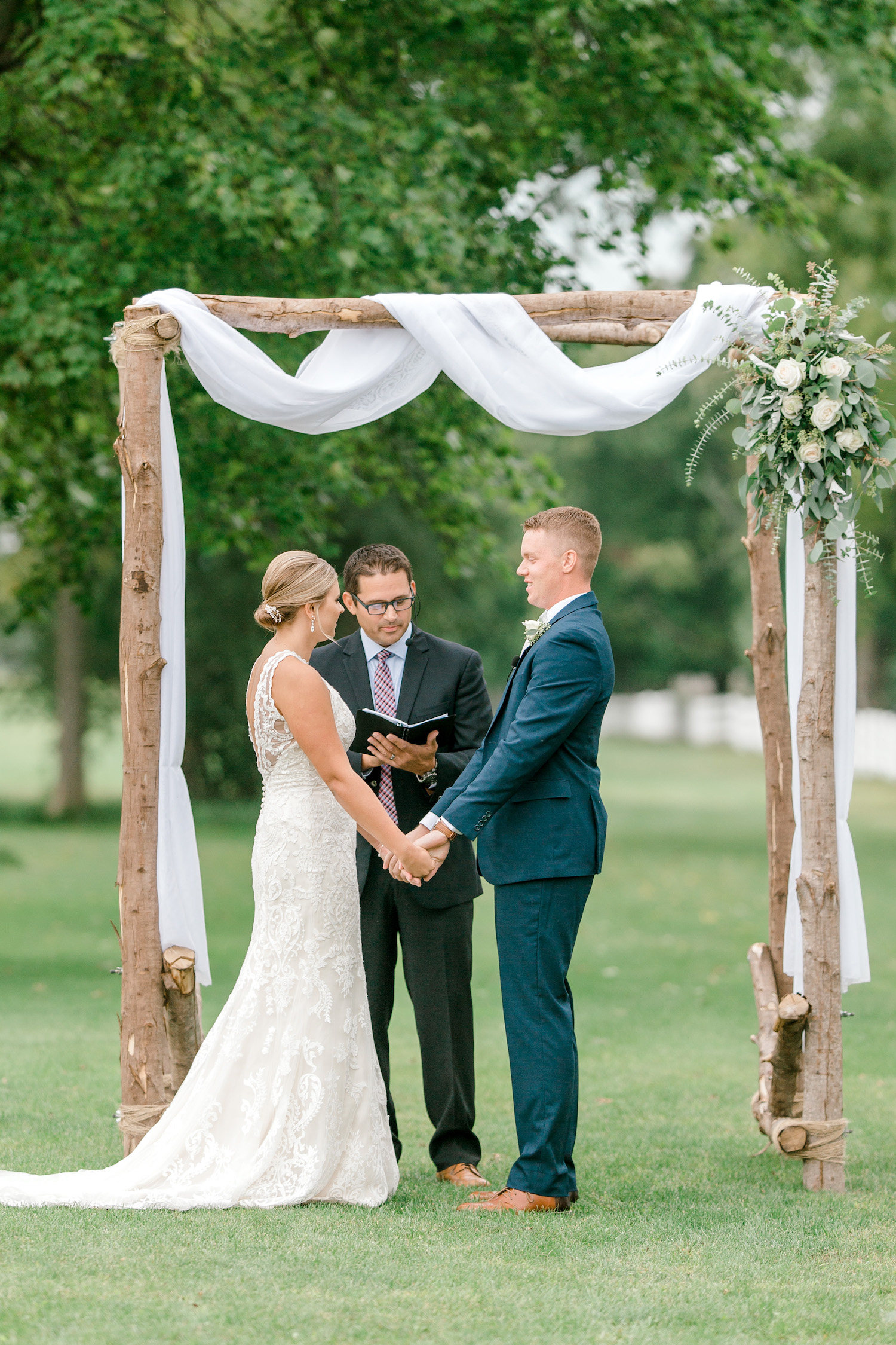 Bride and groom holding hands saying "I do"