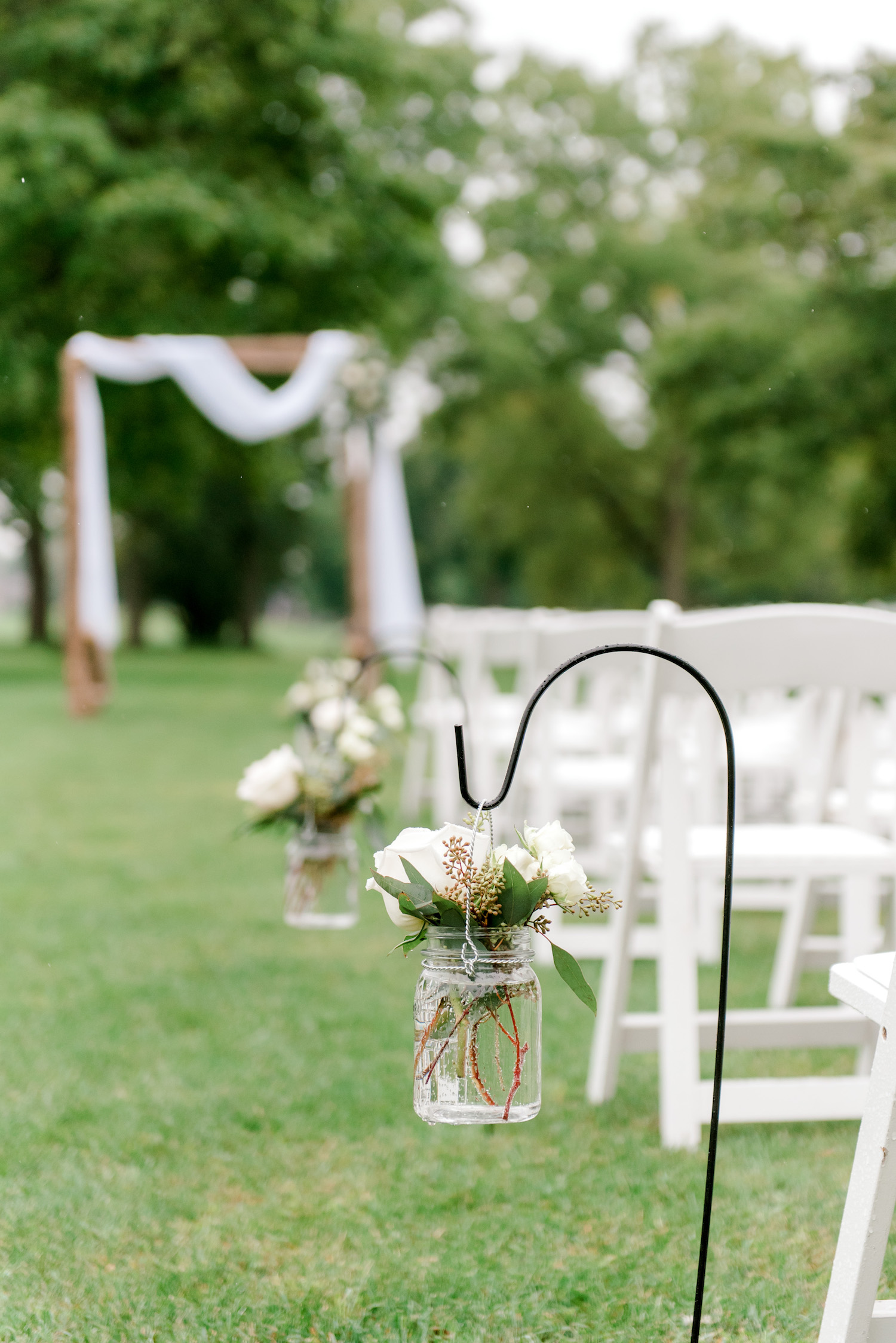 Flowers hanging on hooks along aisle