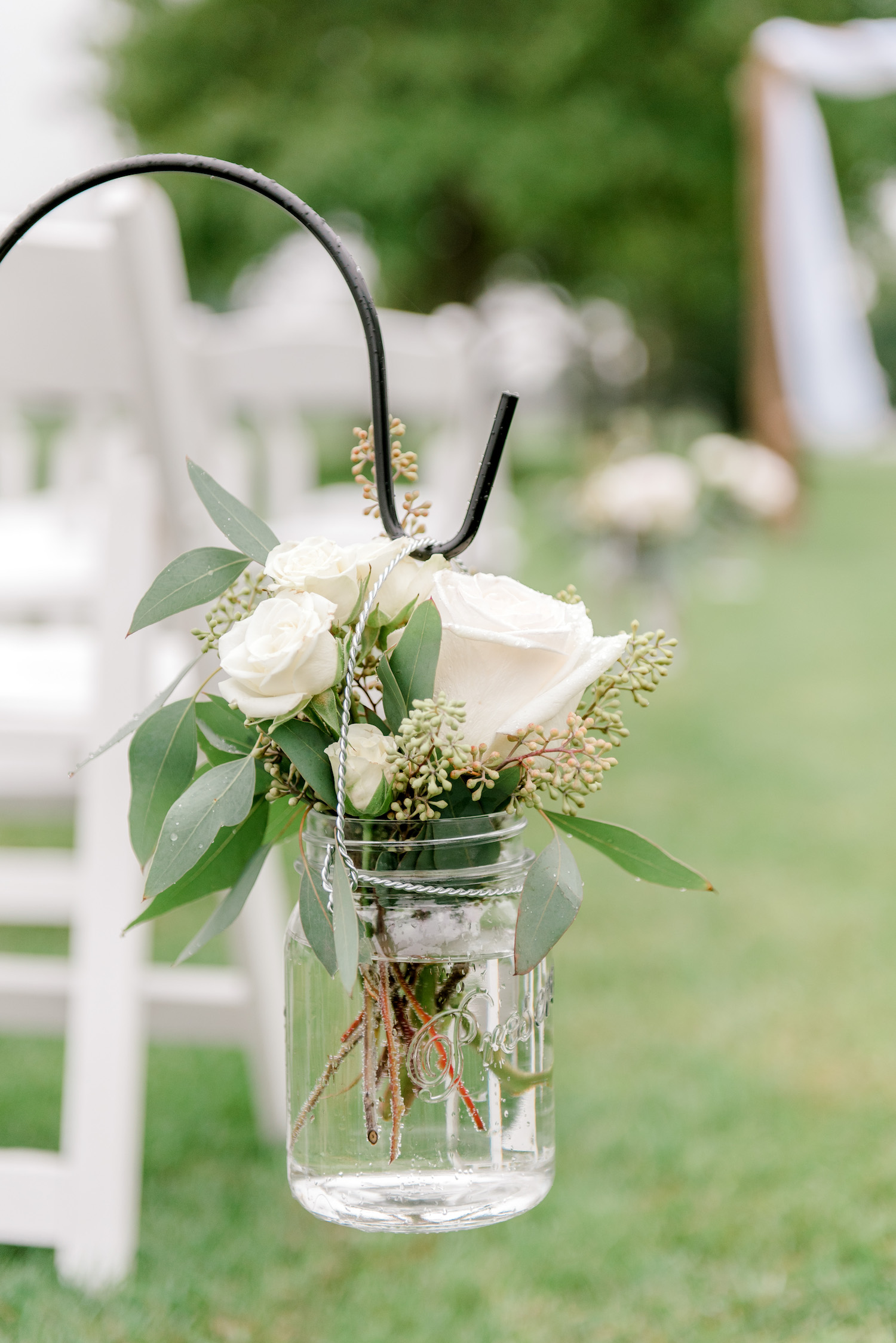 Rose arrangement in jar hanging from hooks