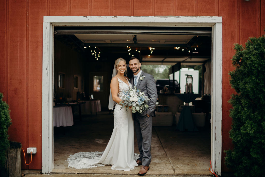 Bride and groom standing in front of barn of Frankfort, IL Wedding