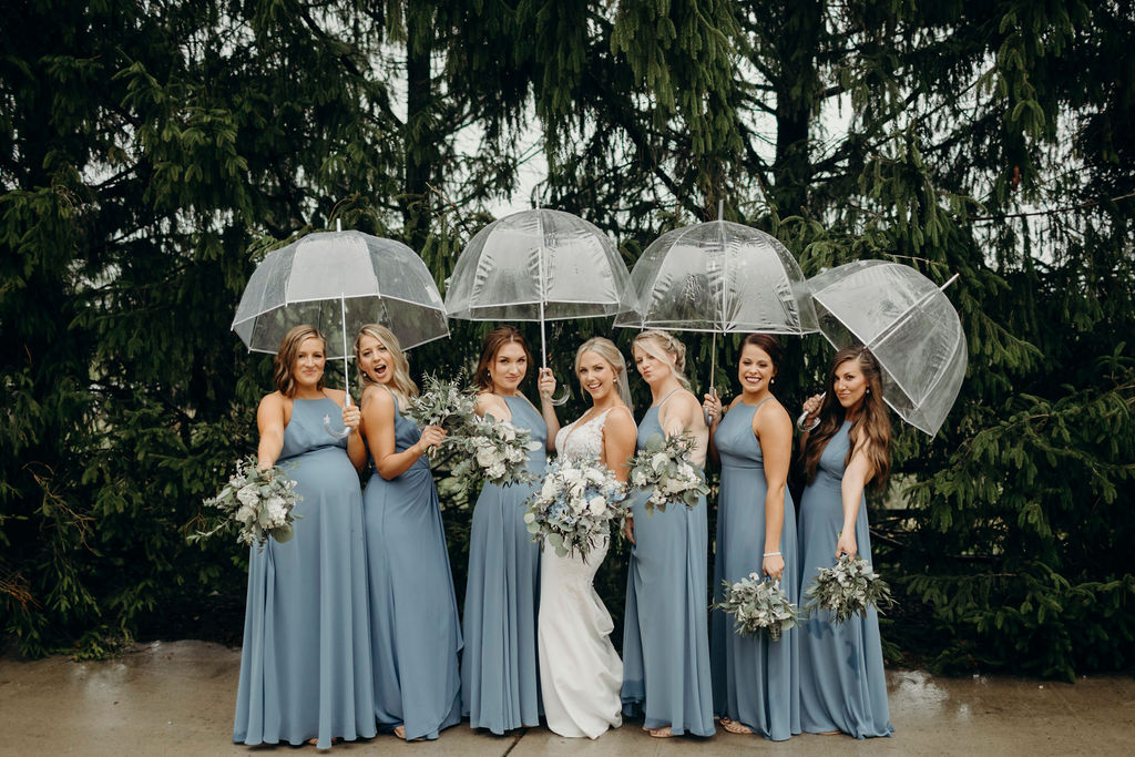 Bride and bridesmaids under umbrellas