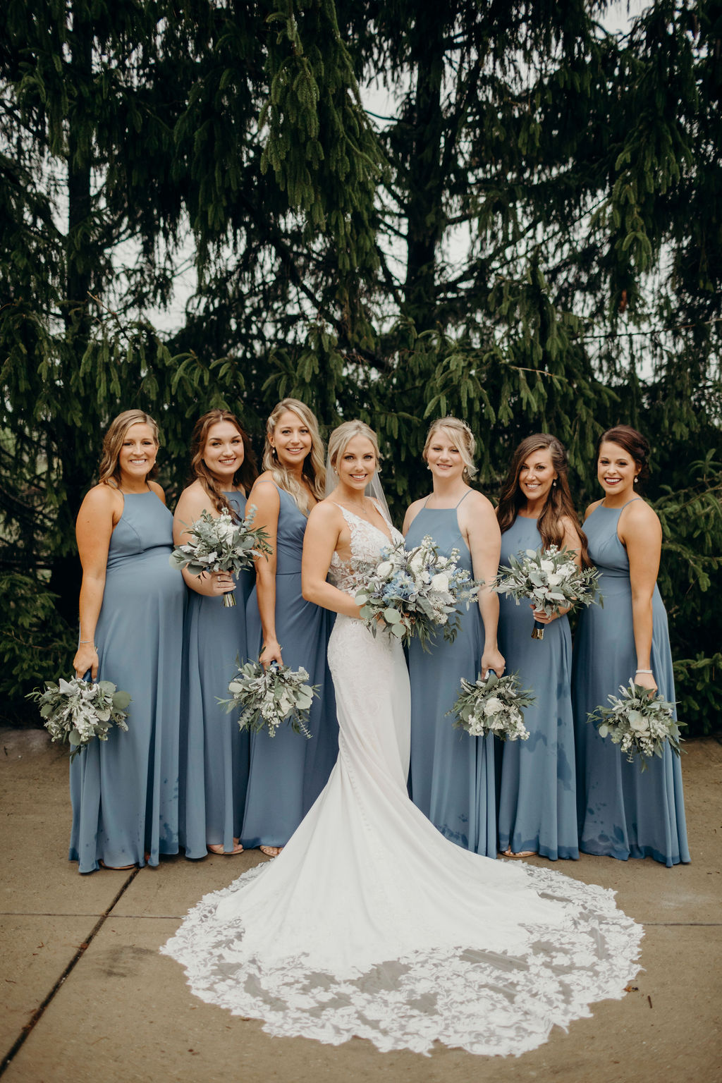 Bride standing with bridesmaids smiling