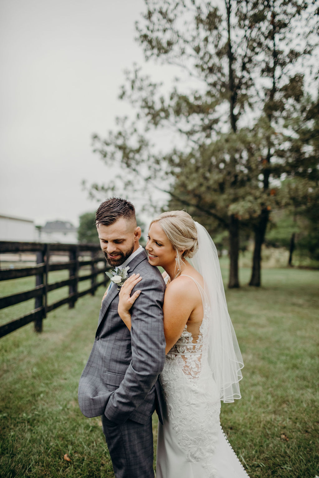 Bride hugging groom from behind before Frankfort, IL Wedding