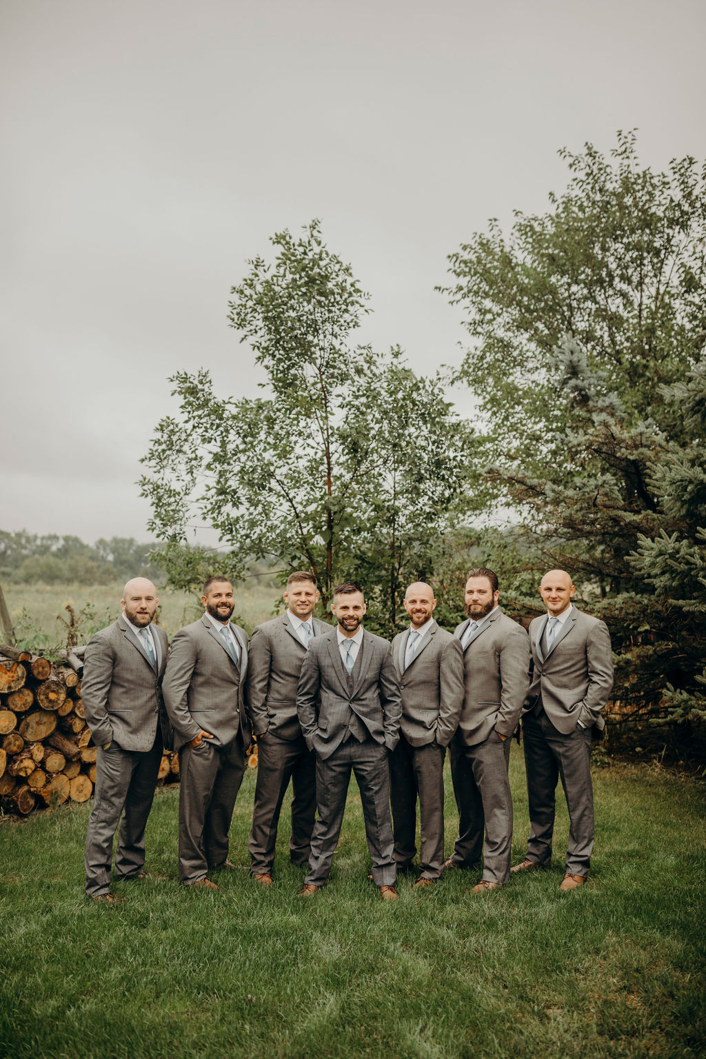 Groomsman standing in front of trees