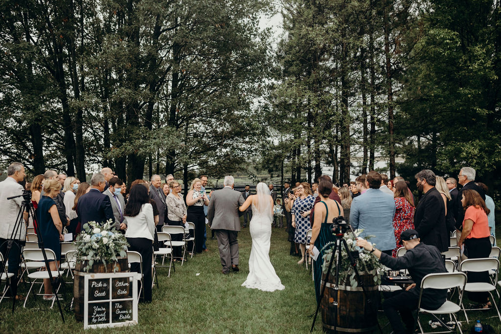 Bride walking with father down aisle