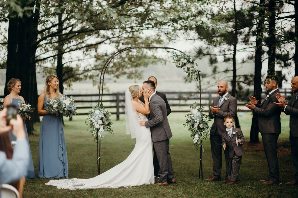 Bride and groom kissing at alter