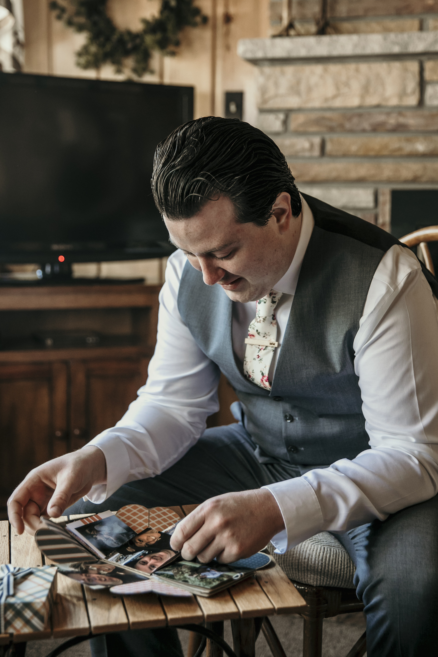 Groom looking at photo book