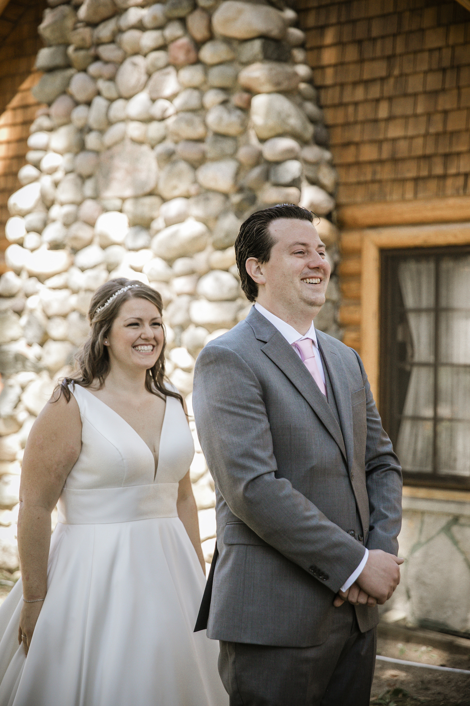 Bride standing behind groom before Higgins lake wedding