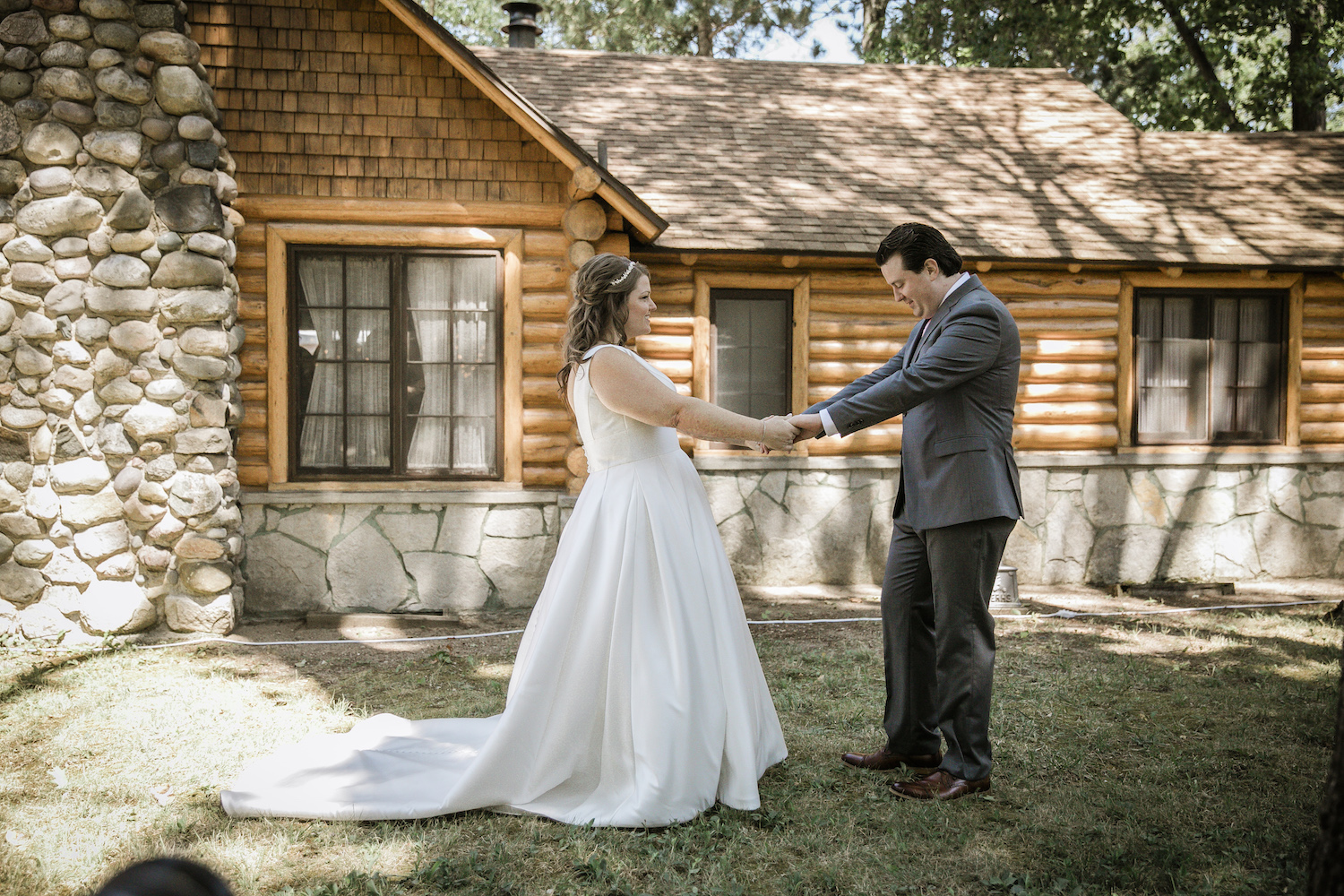 Groom looking at his bride before Higgins Lake wedding