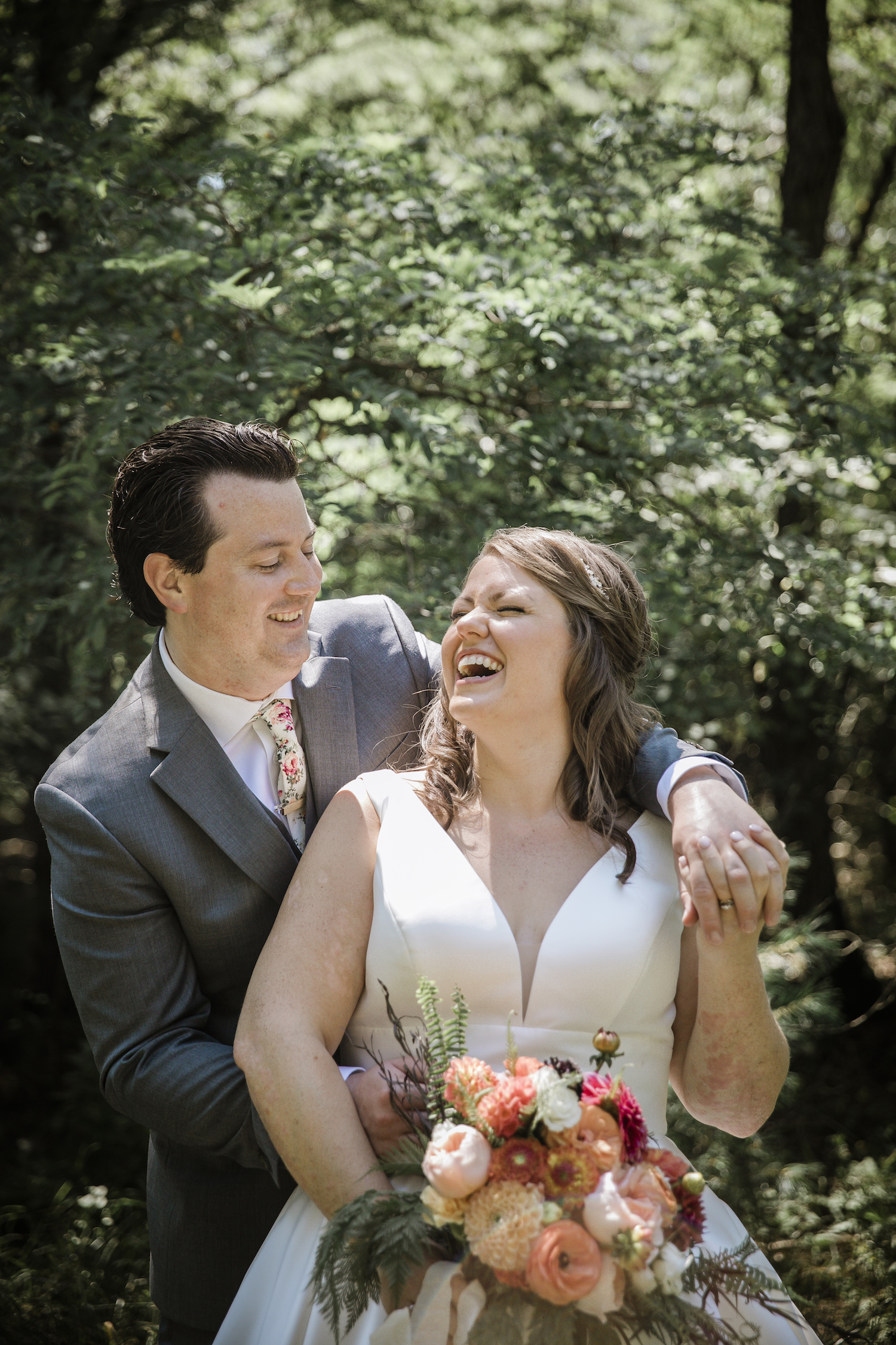 Bride laughing with her groom before Higgins Lake wedding