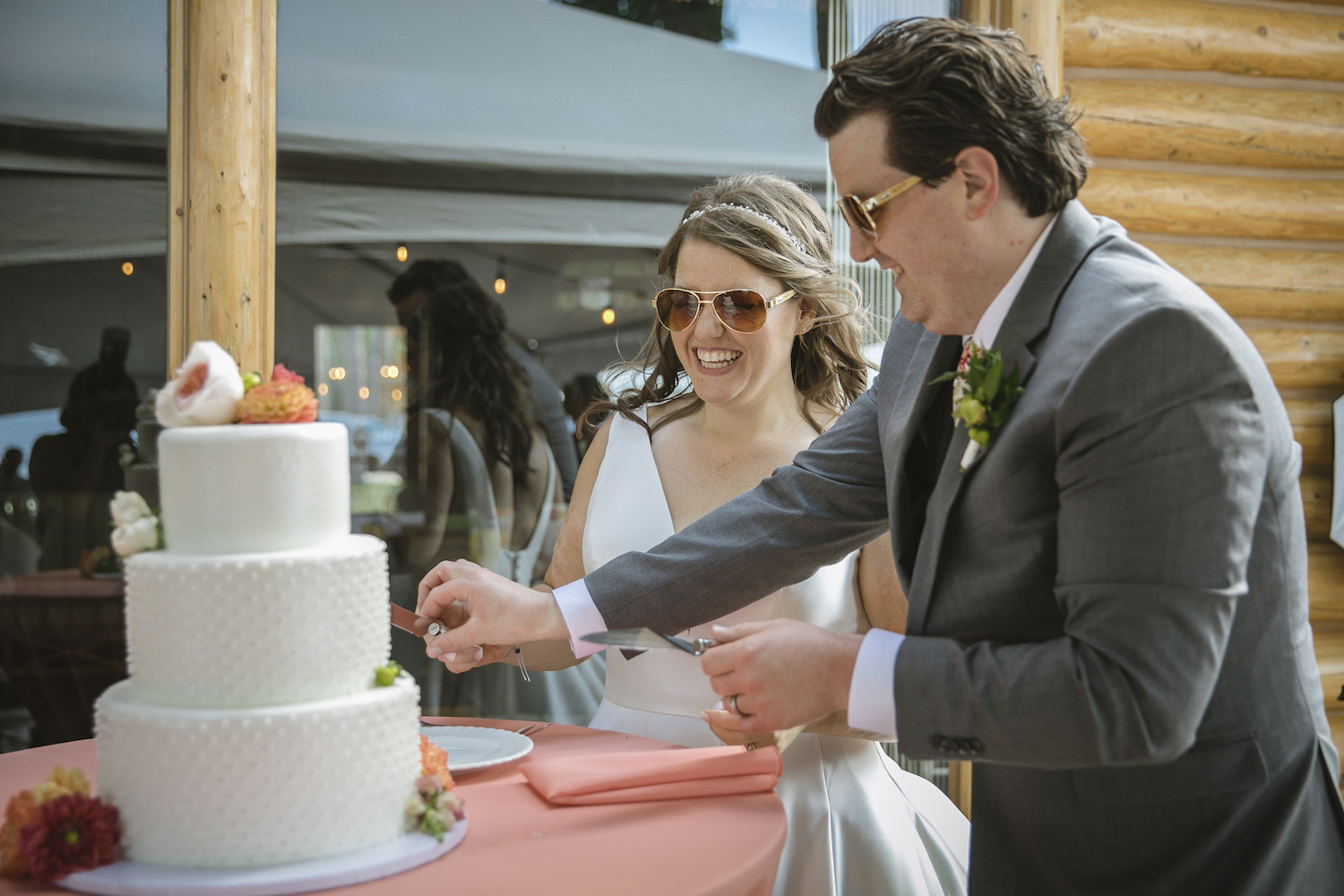 Bride and groom cutting cake smiling