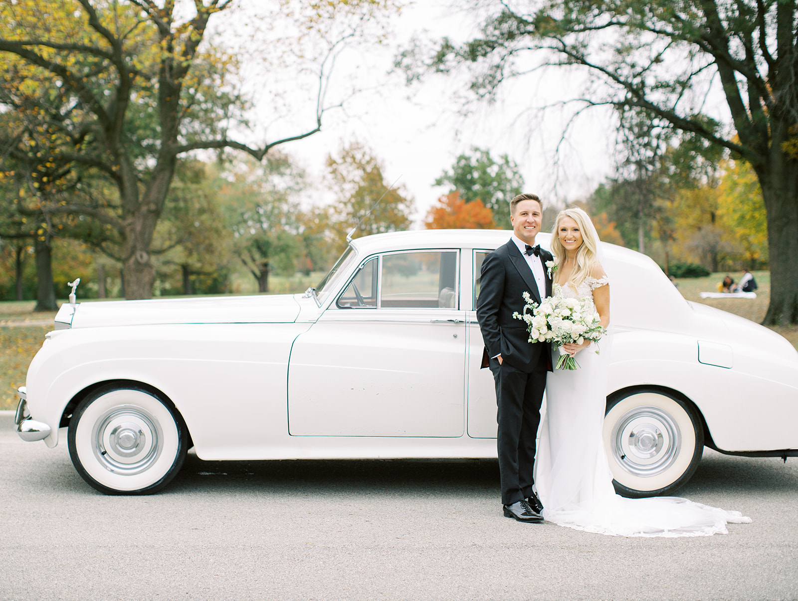 Bride and groom in front of classic car at Ritz Charles wedding