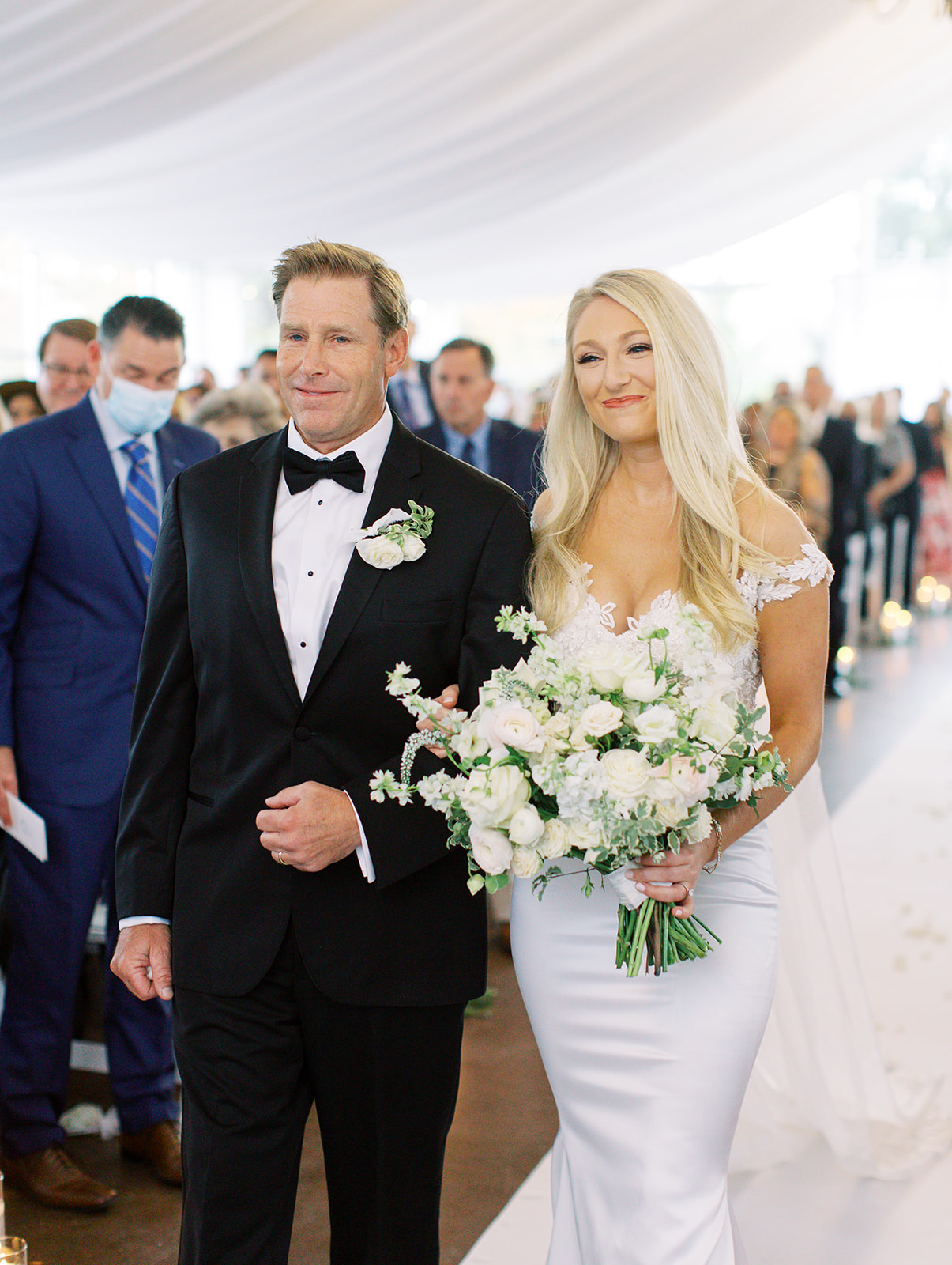 Bride walking down aisle with her father