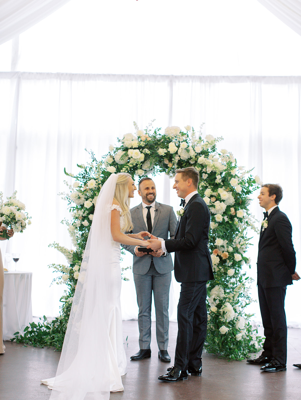 Bride and groom holding hands in front of alter