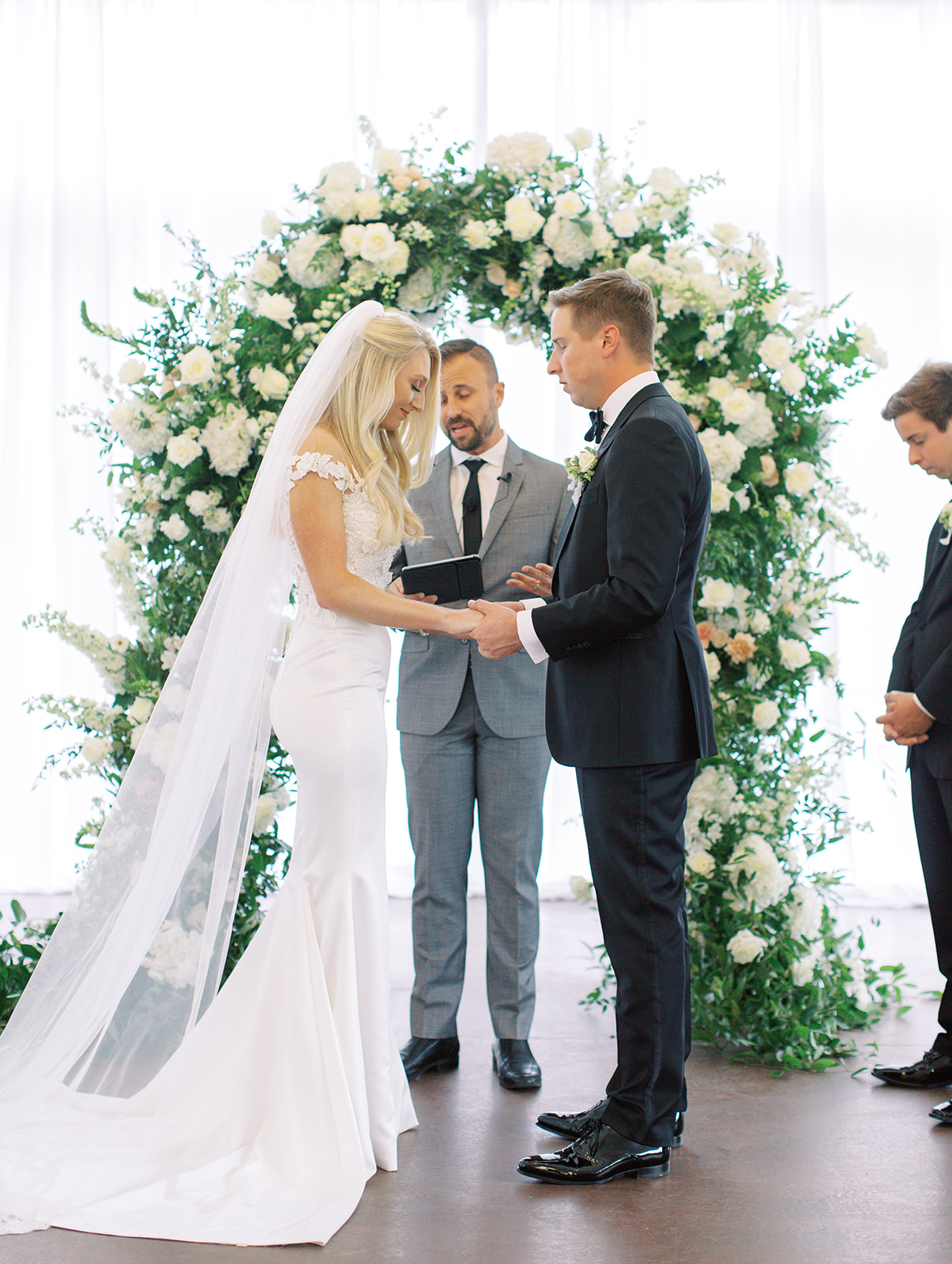 Bride and groom praying together at Ritz Charles wedding ceremony