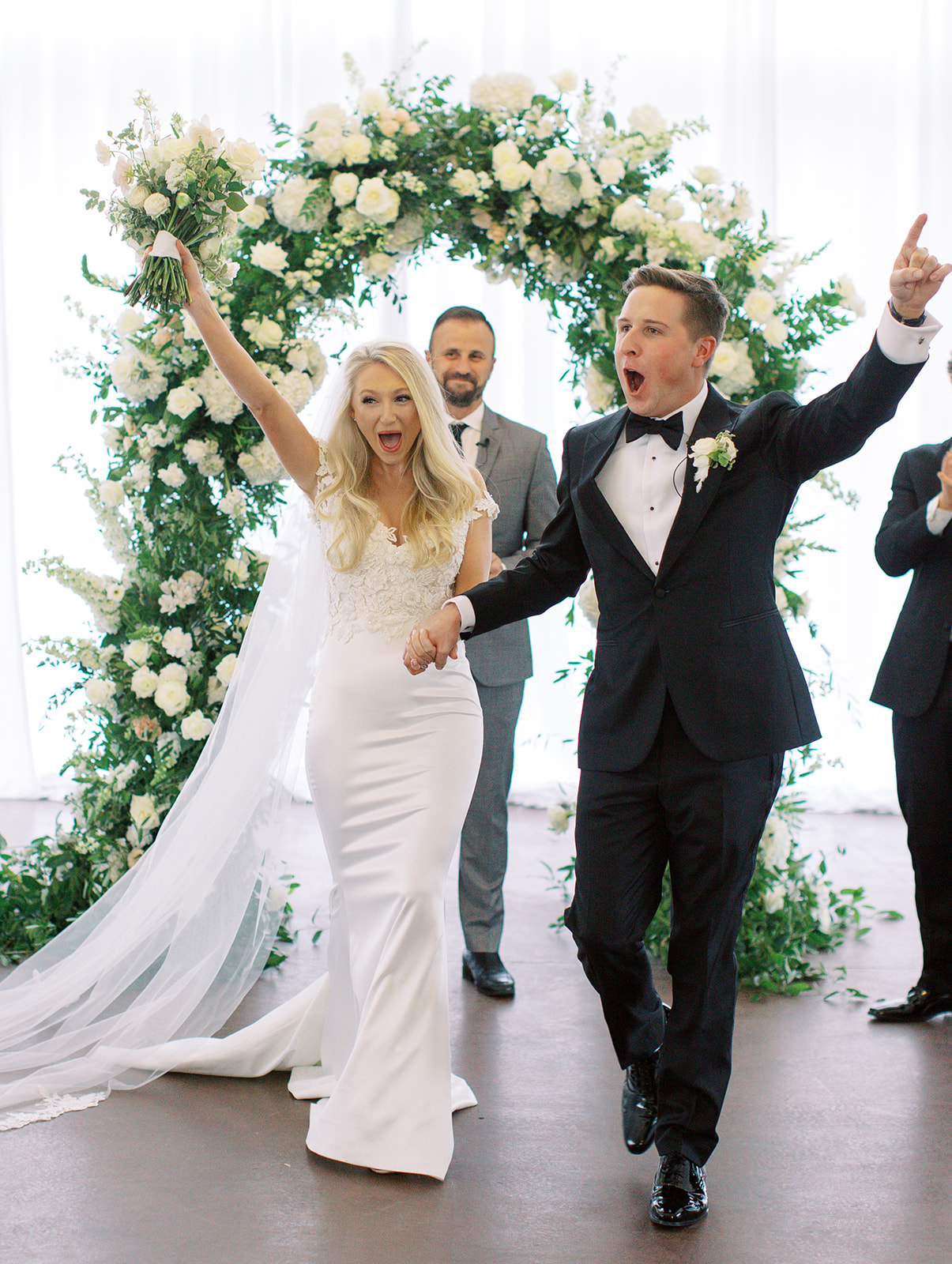 Bride and groom cheering after saying "I do"