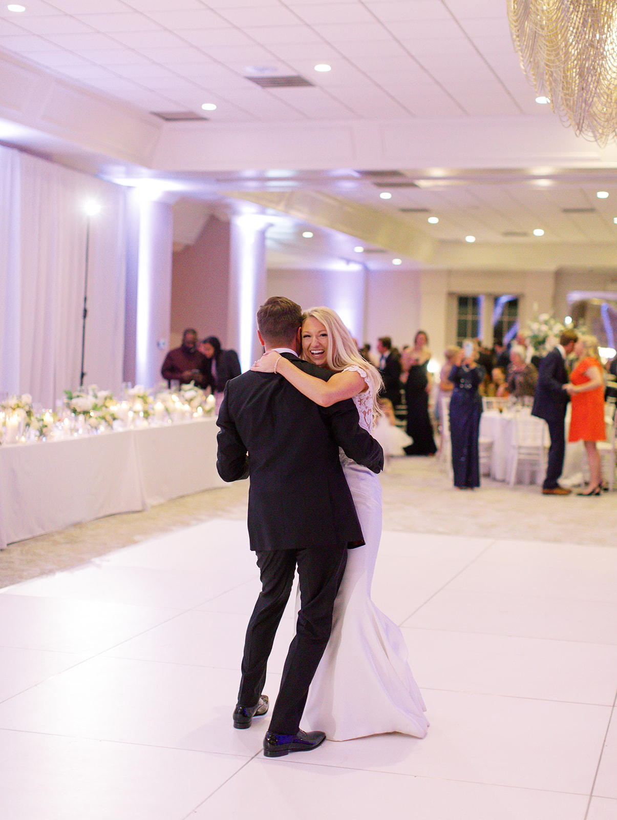 Bride smiling dancing with her husband