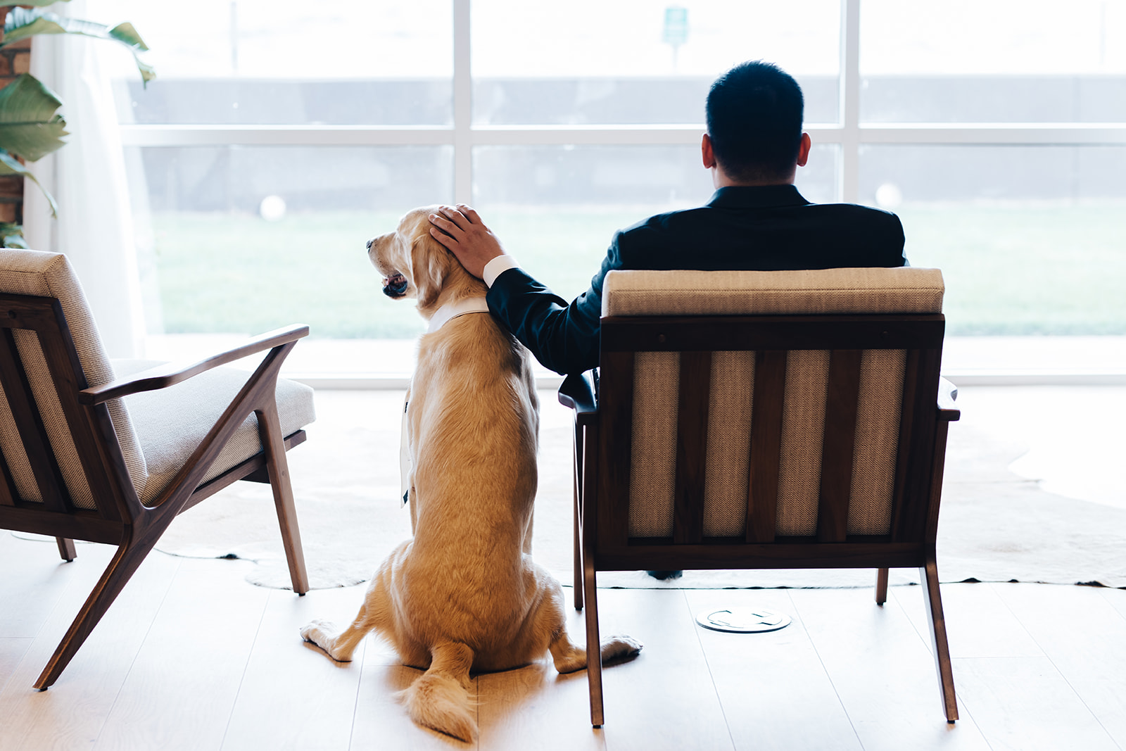 Groom sitting with his dog