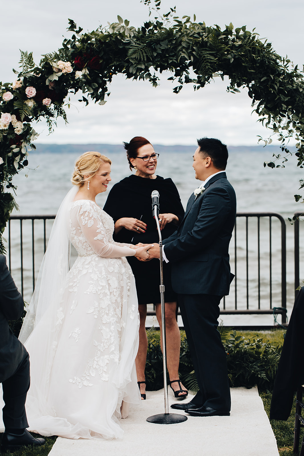 Bride and groom taking hands at alter