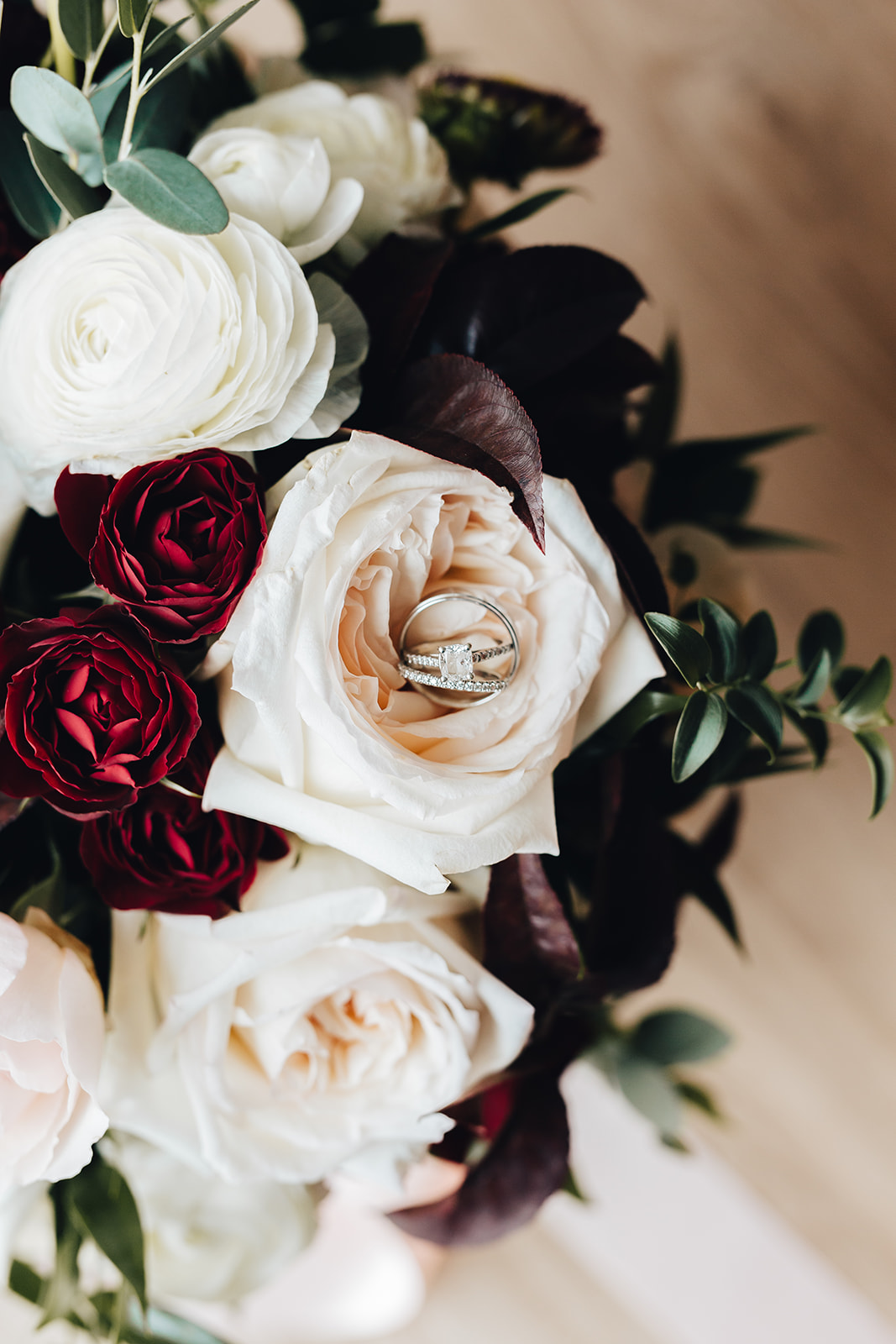 West Bay Wedding rings on floral bouquet 