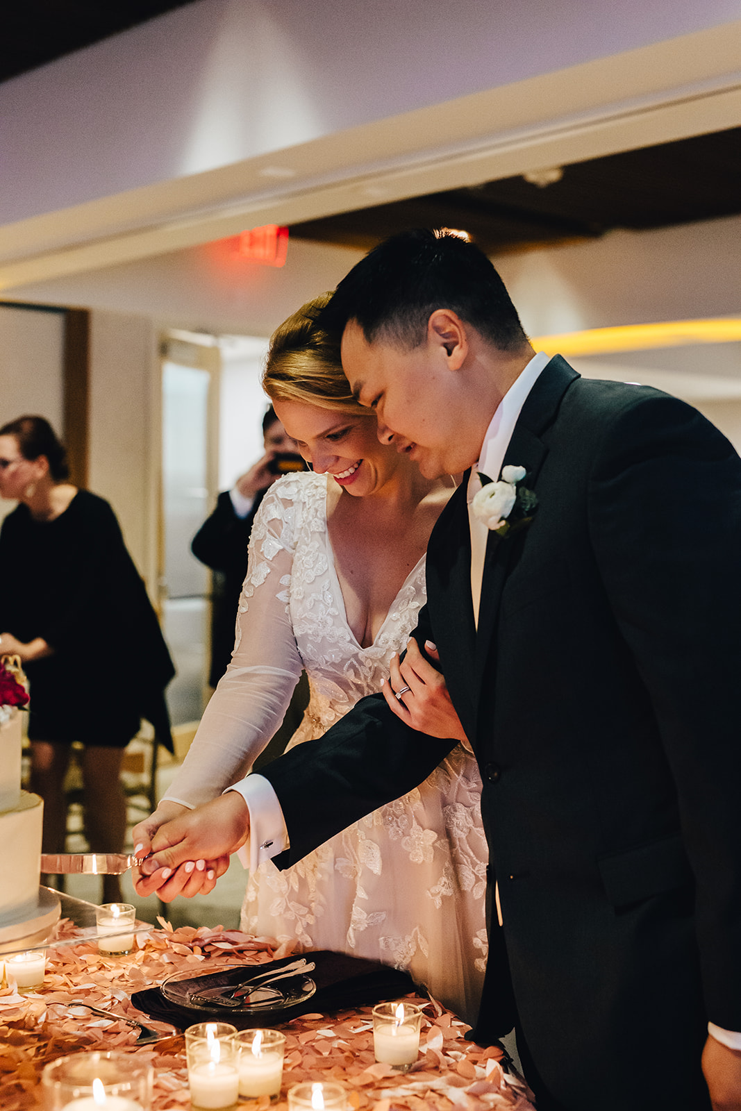 Bride and groom cutting their cake smiling