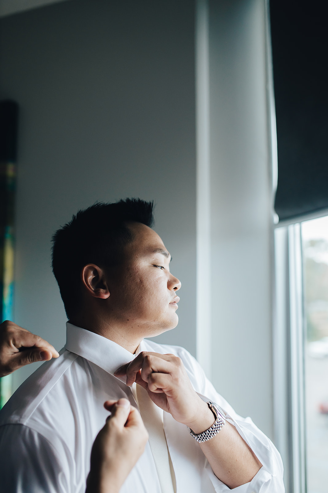 Groom getting ready for West Bay Beach wedding