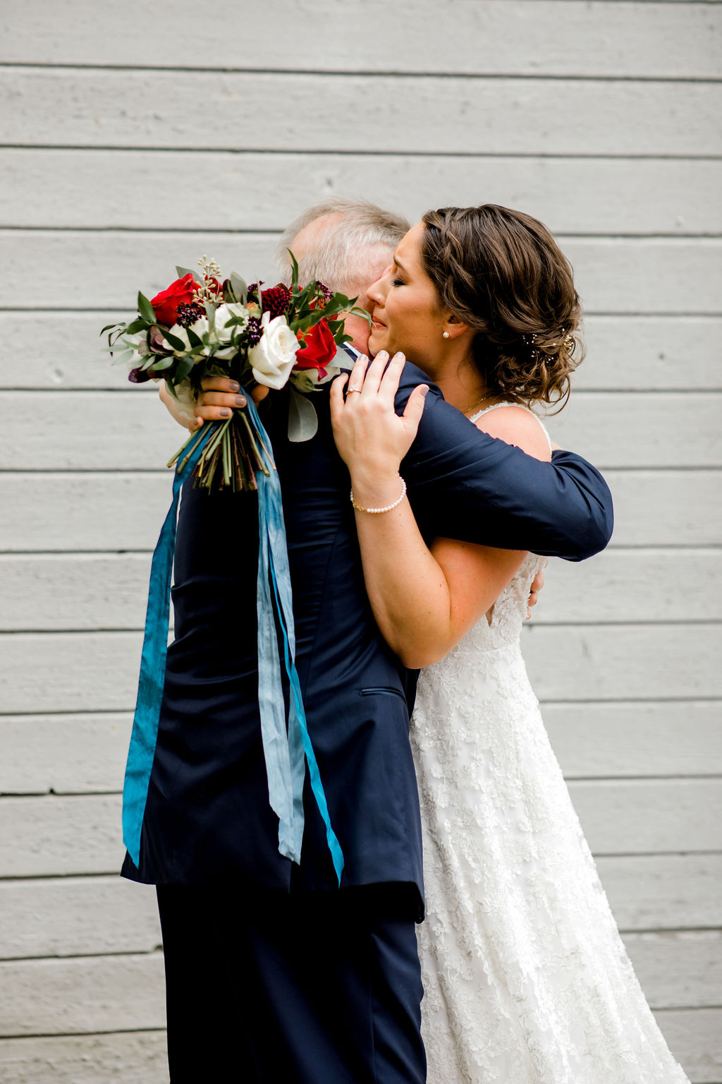 Bride hugging her father before her Jackson, MI wedding