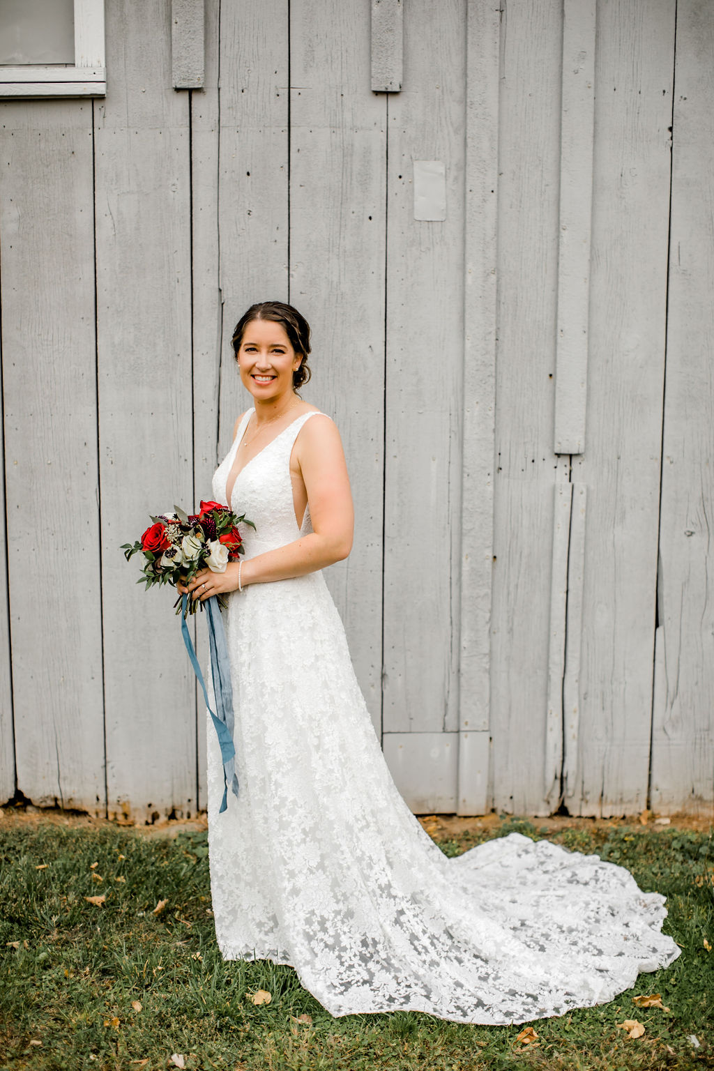 Bride smiling holding her bouquet before Jackson, MI wedding